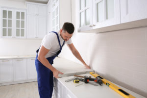 Kitchen Remodeling Installer Performing Installation