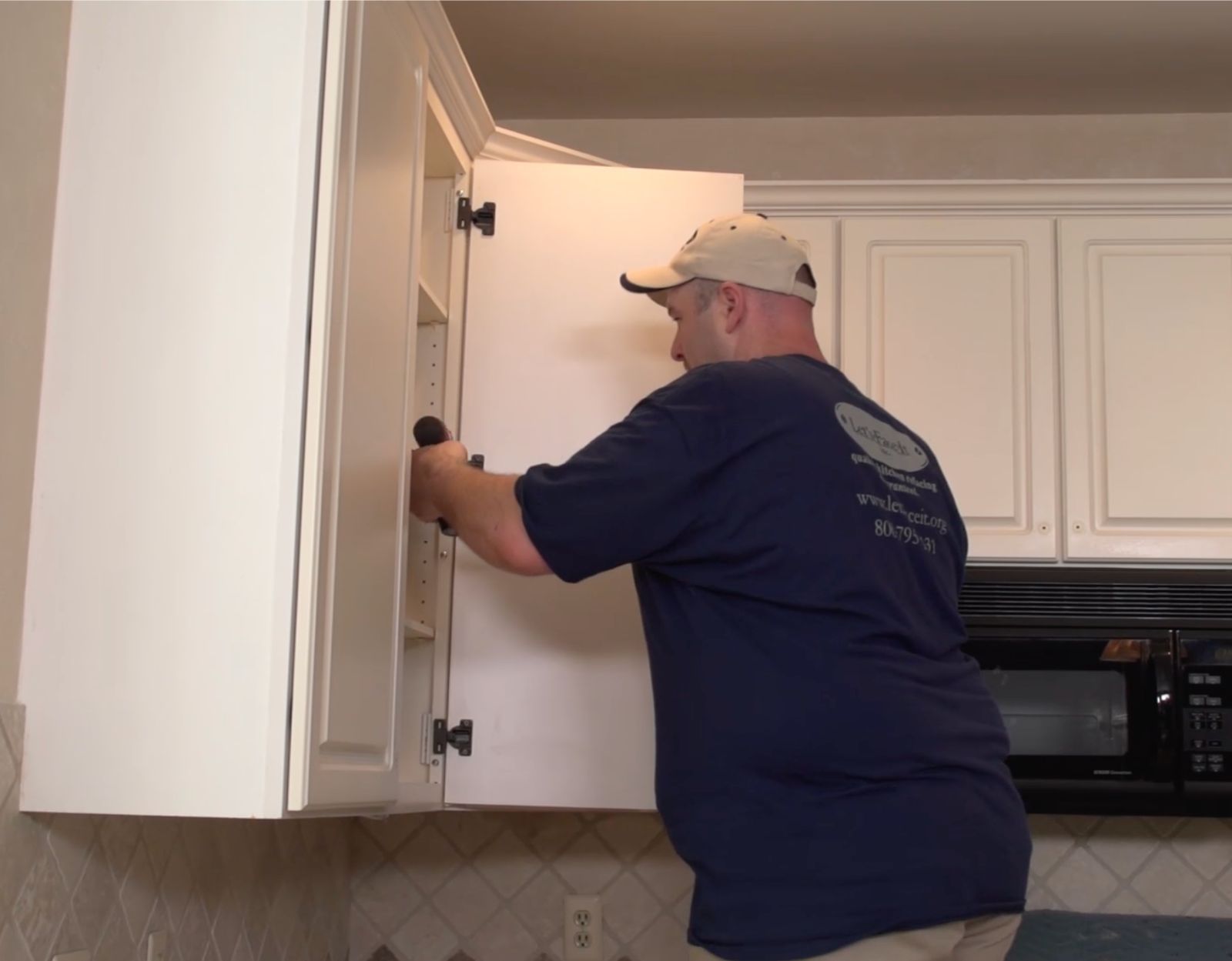 Our Installer Working Inside Cabinet