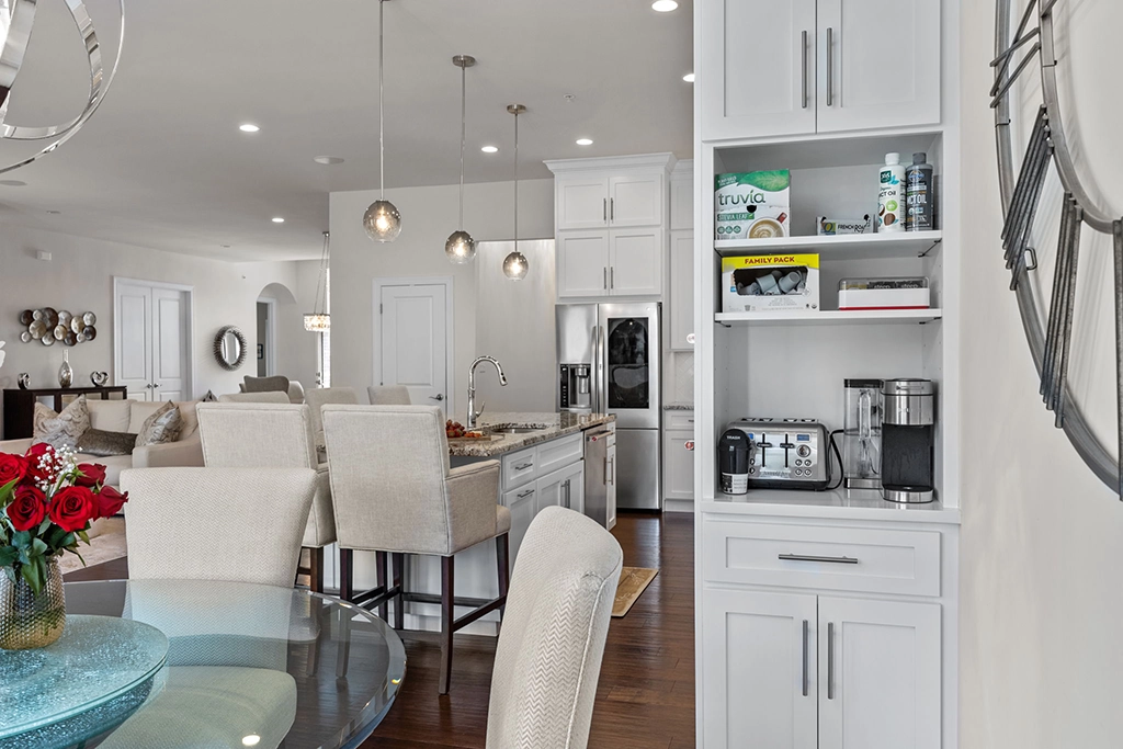Dining area view into white shaker refaced kitchen with custom built-in pantry and coffee station cabinetry