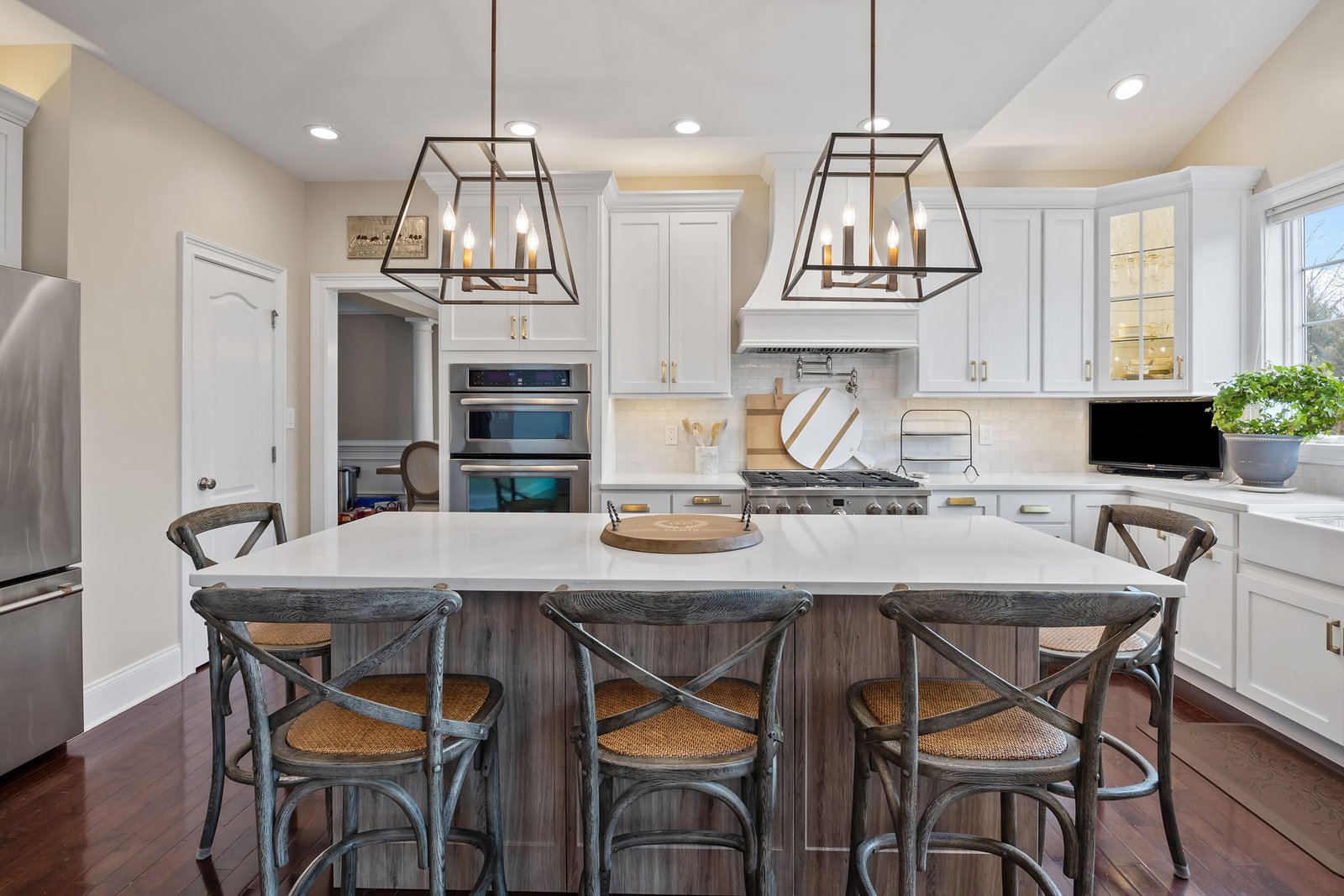 White shaker kitchen cabinet refacing with large island and pendant lights