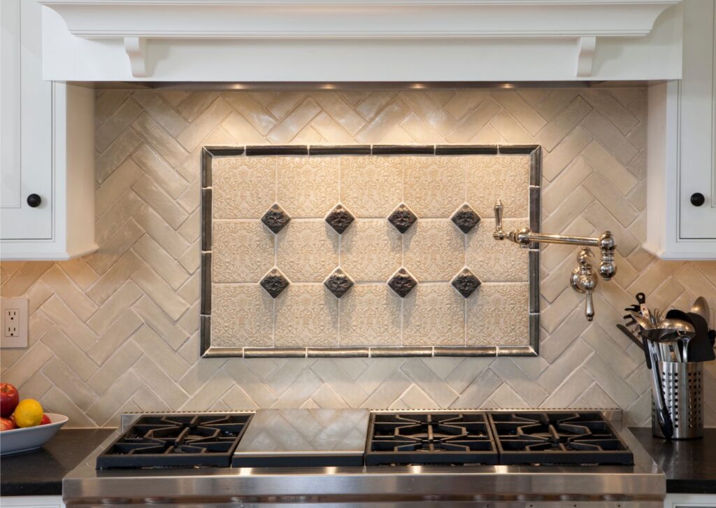 Handcrafted clay tile herringbone backsplash in Wayne, PA
