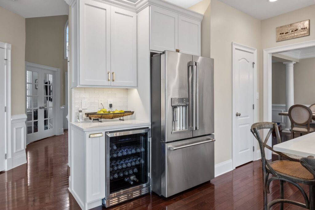 White shaker kitchen cabinets with rollout storage accessory