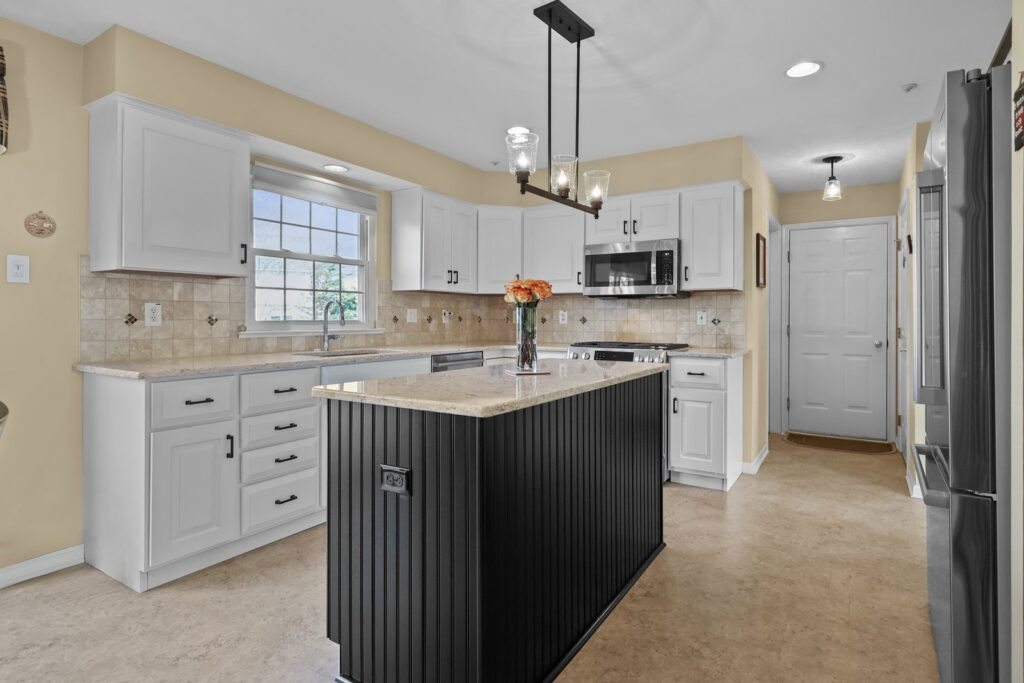 White shaker cabinet refacing with dark island and granite countertops in Warrington, PA